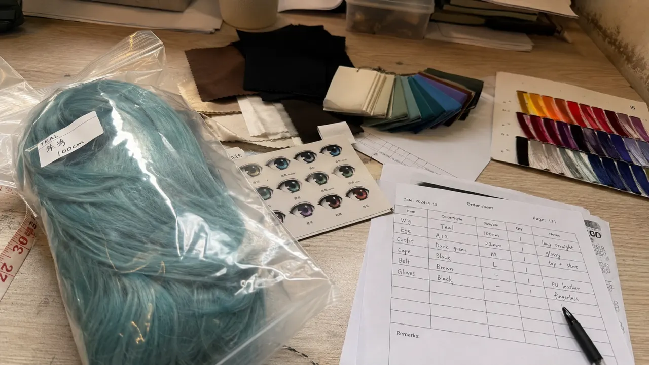 Phone photo of anime-style customization samples on a real work table
