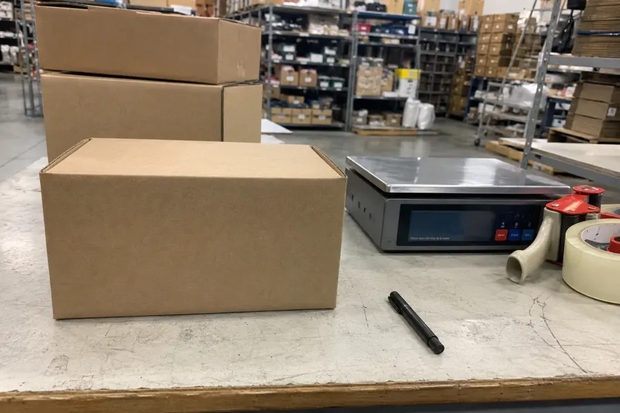 Plain discreet shipping box photographed by phone in warehouse